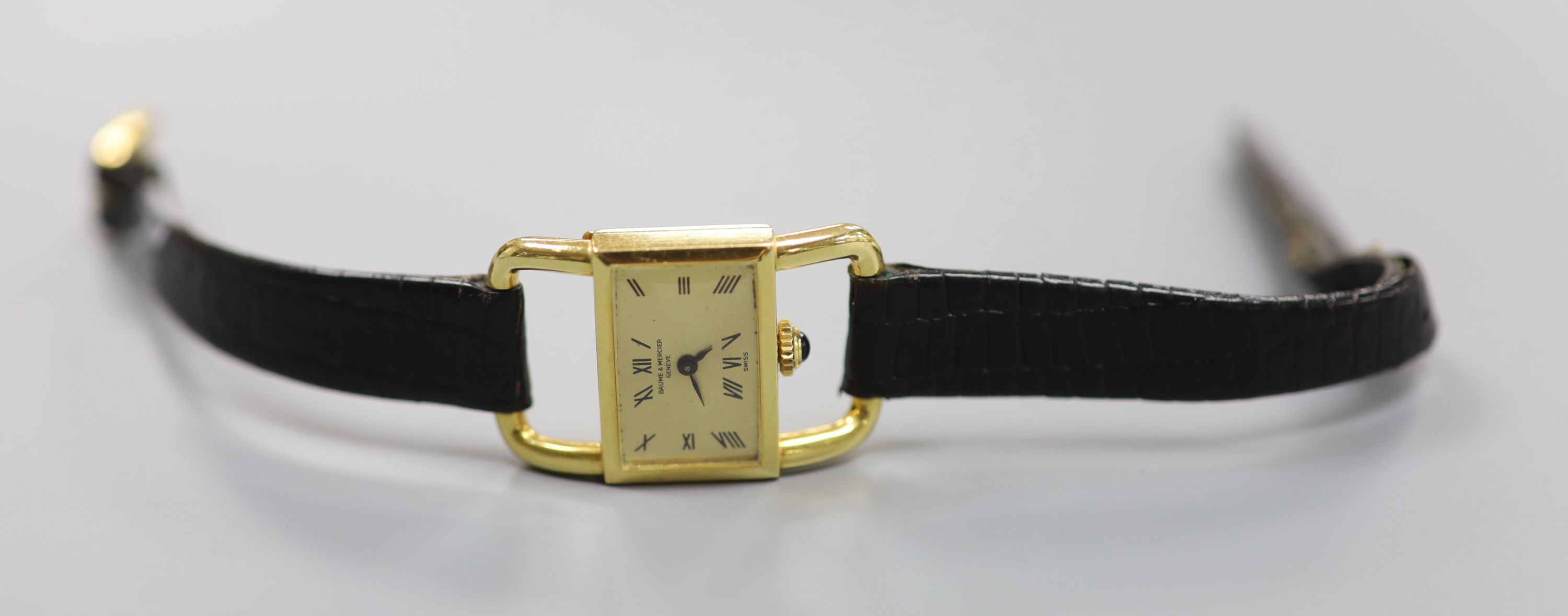 A ladys modern 750 yellow metal Baume & Mercier manual wind rectangular dress wrist watch, on a leather strap (strap a.f.),